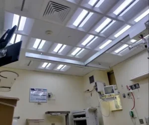 Photo of an ICU patient room equipped with multiple Telelumen Octa LED light synthesizers in the ceiling. The light spectral quality is programmed to a blue enhanced spectrum that looks “cool” to the human eye.