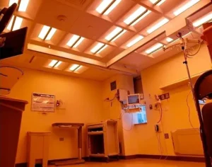 Photo of an ICU patient room equipped with multiple Telelumen Octa LED light synthesizers in the ceiling. The light spectral quality is programmed to a red enhanced spectrum that looks “warm” to the human eye.