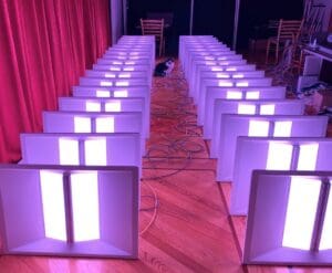 Two rows of Telelumen Octa full spectrum LED luminaires being tested before shipment to customers.