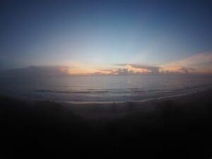 Photo of a beautiful beach sunrise showing the deep blue, yellow and red light frequencies contained in the natural light spectrum that all humans experience and enjoy.