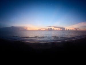 Photo of a beautiful beach sunrise showing the deep blue, yellow and red light frequencies contained in the natural light spectrum that all humans experience and enjoy.
