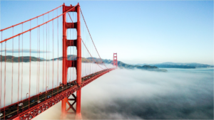 Golden Gate Bridge amidst dense morning fog.